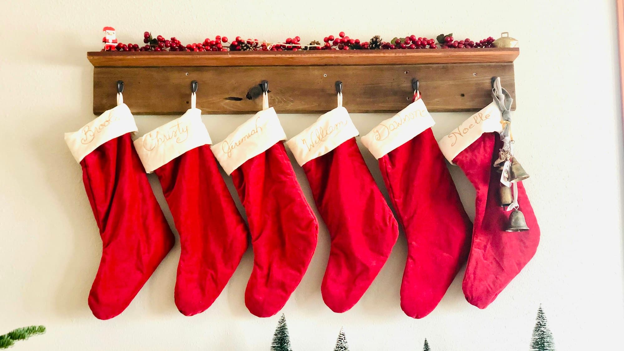 A coordinated row of red and white Christmas stockings hung in a line, the matched-set look that reads as intentional decor