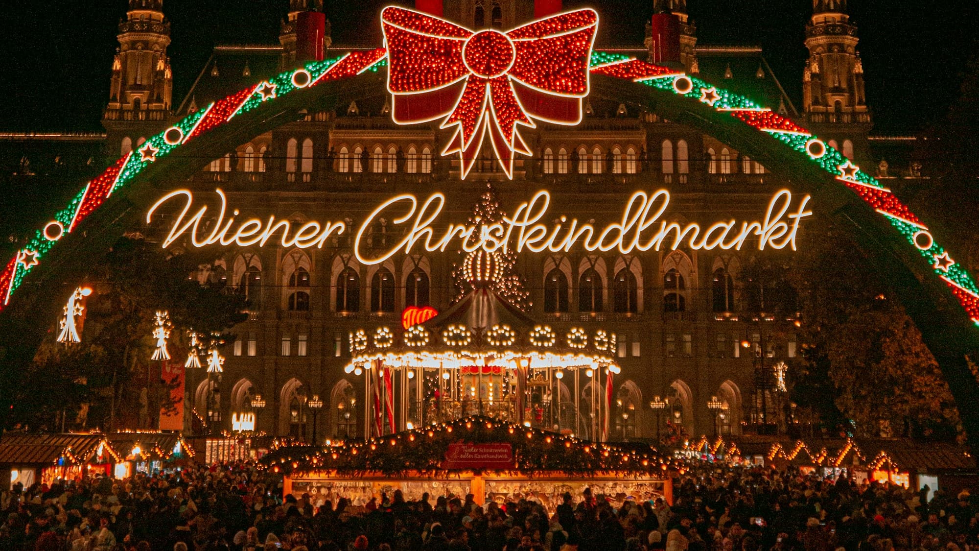 A large illuminated Christmas tree and light display at a Christmas market in Vienna, Austria, at night